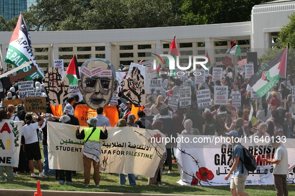 Hundreds of people join a demonstration in solidarity with the Palestinian people at The Grassy Knoll to mark the first anniversary of the w...