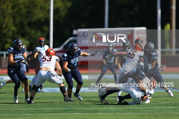 Princeton Tigers quarterback Blaine Hipa #15 is taken down by Columbia Lions defensive lineman Justin Townsend #36 during action in the NCAA...