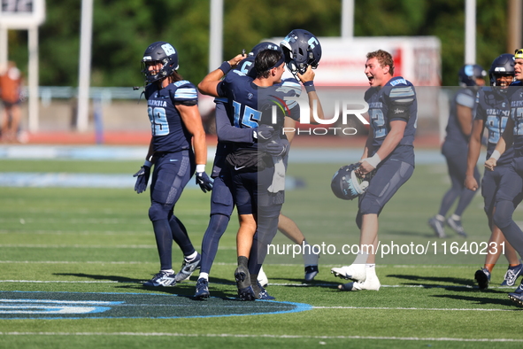 Columbia Lions quarterback Chase Goodwin #15 celebrates with teammates as time expires during the NCAA football game against the Princeton T...