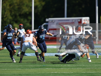 Princeton Tigers quarterback Blaine Hipa #15 is taken down by Columbia Lions defensive lineman Justin Townsend #36 during action in the NCAA...