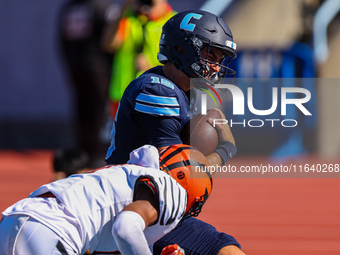 Columbia Lions quarterback Chase Goodwin #15 is hit by a defender as he goes in for a touchdown during the NCAA football game against the Pr...