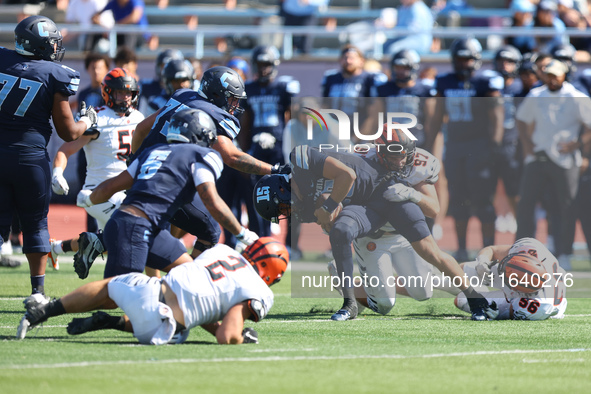 Columbia Lions quarterback Chase Goodwin #15 is taken down by Princeton Tigers defensive lineman Rocco Marcelino #97 after a short gain duri...