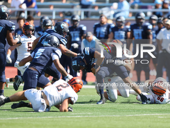 Columbia Lions quarterback Chase Goodwin #15 is taken down by Princeton Tigers defensive lineman Rocco Marcelino #97 after a short gain duri...