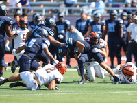 Columbia Lions quarterback Chase Goodwin #15 is taken down by Princeton Tigers defensive lineman Rocco Marcelino #97 after a short gain duri...