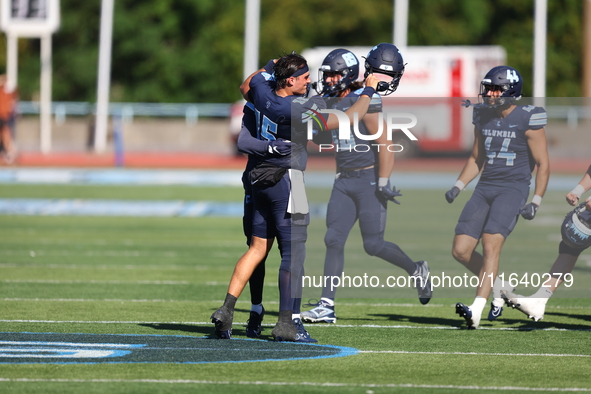 Columbia Lions quarterback Chase Goodwin #15 celebrates with teammates as time expires during the NCAA football game against the Princeton T...