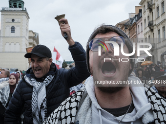 People take part in a protest in support of Palestine, in Warsaw, Poland, on October 5, 2024. Protesters march from the city center to the U...