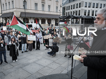 People take part in a protest in support of Palestine, in Warsaw, Poland, on October 5, 2024. Protesters march from the city center to the U...