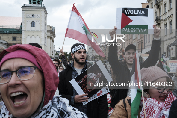 People take part in a protest in support of Palestine, in Warsaw, Poland, on October 5, 2024. Protesters march from the city center to the U...