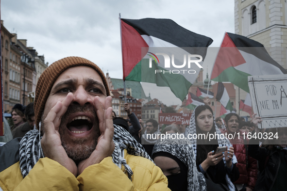 People take part in a protest in support of Palestine, in Warsaw, Poland, on October 5, 2024. Protesters march from the city center to the U...