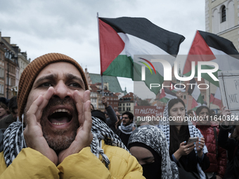 People take part in a protest in support of Palestine, in Warsaw, Poland, on October 5, 2024. Protesters march from the city center to the U...