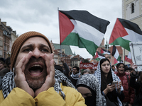 People take part in a protest in support of Palestine, in Warsaw, Poland, on October 5, 2024. Protesters march from the city center to the U...