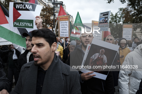 People take part in a protest in support of Palestine, in Warsaw, Poland, on October 5, 2024. Protesters march from the city center to the U...