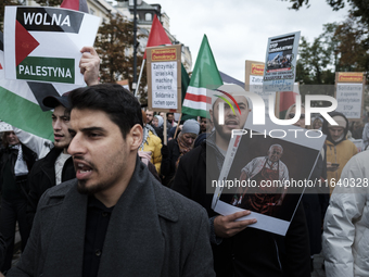 People take part in a protest in support of Palestine, in Warsaw, Poland, on October 5, 2024. Protesters march from the city center to the U...