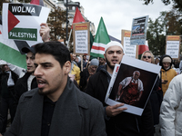 People take part in a protest in support of Palestine, in Warsaw, Poland, on October 5, 2024. Protesters march from the city center to the U...