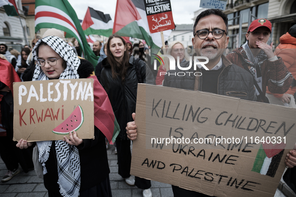 People take part in a protest in support of Palestine, in Warsaw, Poland, on October 5, 2024. Protesters march from the city center to the U...