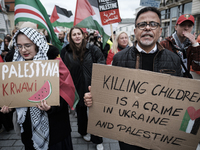 People take part in a protest in support of Palestine, in Warsaw, Poland, on October 5, 2024. Protesters march from the city center to the U...