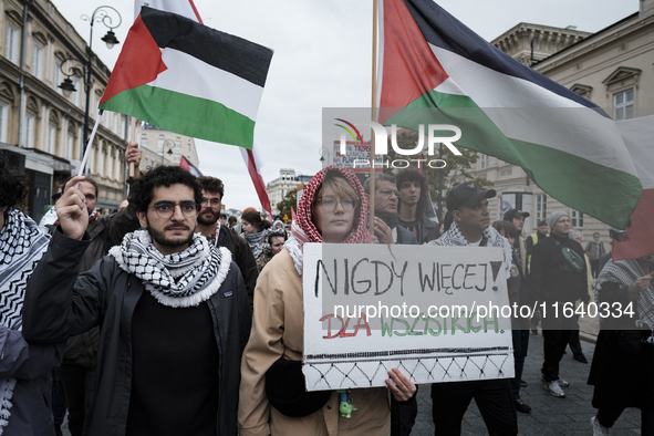 People take part in a protest in support of Palestine, in Warsaw, Poland, on October 5, 2024. Protesters march from the city center to the U...