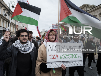 People take part in a protest in support of Palestine, in Warsaw, Poland, on October 5, 2024. Protesters march from the city center to the U...