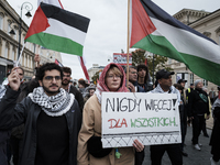 People take part in a protest in support of Palestine, in Warsaw, Poland, on October 5, 2024. Protesters march from the city center to the U...