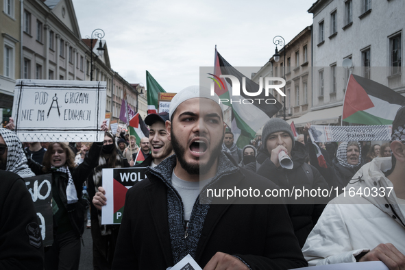 People take part in a protest in support of Palestine, in Warsaw, Poland, on October 5, 2024. Protesters march from the city center to the U...