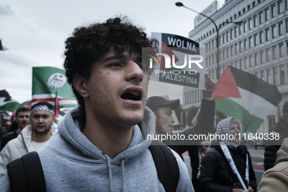 People take part in a protest in support of Palestine, in Warsaw, Poland, on October 5, 2024. Protesters march from the city center to the U...