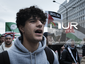 People take part in a protest in support of Palestine, in Warsaw, Poland, on October 5, 2024. Protesters march from the city center to the U...