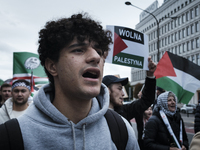 People take part in a protest in support of Palestine, in Warsaw, Poland, on October 5, 2024. Protesters march from the city center to the U...