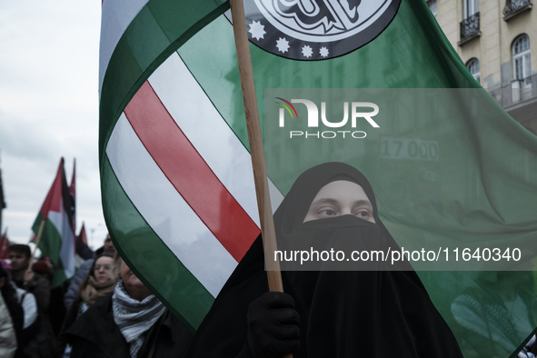 People take part in a protest in support of Palestine, in Warsaw, Poland, on October 5, 2024. Protesters march from the city center to the U...