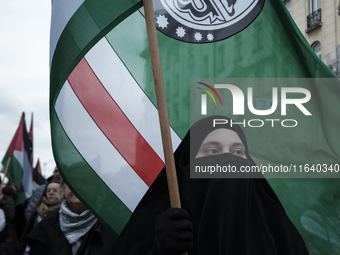 People take part in a protest in support of Palestine, in Warsaw, Poland, on October 5, 2024. Protesters march from the city center to the U...