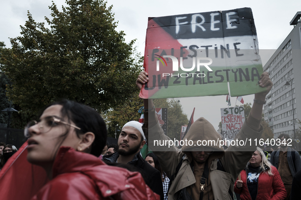 People take part in a protest in support of Palestine, in Warsaw, Poland, on October 5, 2024. Protesters march from the city center to the U...