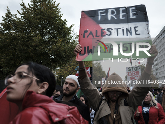 People take part in a protest in support of Palestine, in Warsaw, Poland, on October 5, 2024. Protesters march from the city center to the U...