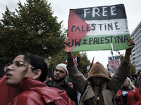 People take part in a protest in support of Palestine, in Warsaw, Poland, on October 5, 2024. Protesters march from the city center to the U...