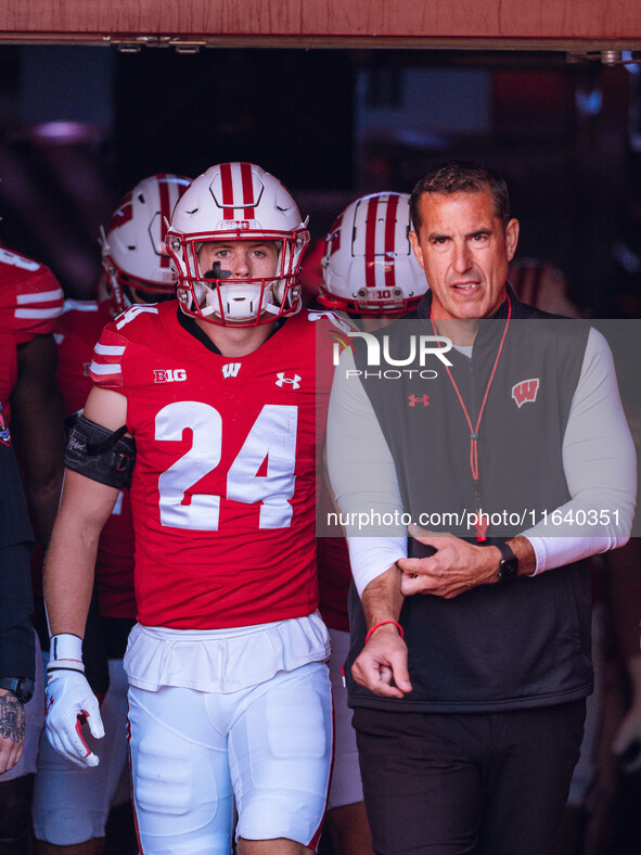 Wisconsin Badgers safety Hunter Wohler #24 and Head Coach Luke Fickell walk out of the tunnel at Camp Randall Stadium in Madison, Wisconsin,...