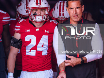 Wisconsin Badgers safety Hunter Wohler #24 and Head Coach Luke Fickell walk out of the tunnel at Camp Randall Stadium in Madison, Wisconsin,...