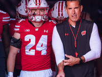 Wisconsin Badgers safety Hunter Wohler #24 and Head Coach Luke Fickell walk out of the tunnel at Camp Randall Stadium in Madison, Wisconsin,...