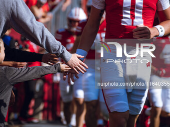 The Wisconsin Badgers walk out of the tunnel against the Purdue Boilermakers at Camp Randall Stadium in Madison, Wisconsin, on October 5, 20...