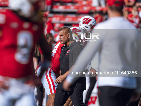 Wisconsin Badgers Offensive Coordinator Phil Longo leads warmups for the Wisconsin Badgers against the Purdue Boilermakers at Camp Randall S...