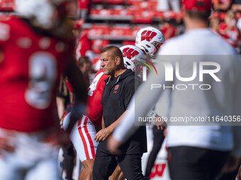 Wisconsin Badgers Offensive Coordinator Phil Longo leads warmups for the Wisconsin Badgers against the Purdue Boilermakers at Camp Randall S...