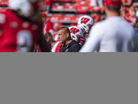 Wisconsin Badgers Offensive Coordinator Phil Longo leads warmups for the Wisconsin Badgers against the Purdue Boilermakers at Camp Randall S...