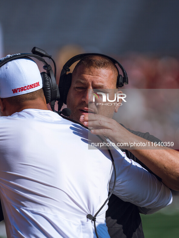 Wisconsin Badgers Offensive Coordinator Phil Longo embraces a member of the coaching staff minutes before the Wisconsin Badgers vs. Purdue B...