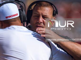 Wisconsin Badgers Offensive Coordinator Phil Longo embraces a member of the coaching staff minutes before the Wisconsin Badgers vs. Purdue B...