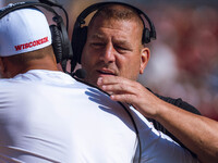 Wisconsin Badgers Offensive Coordinator Phil Longo embraces a member of the coaching staff minutes before the Wisconsin Badgers vs. Purdue B...