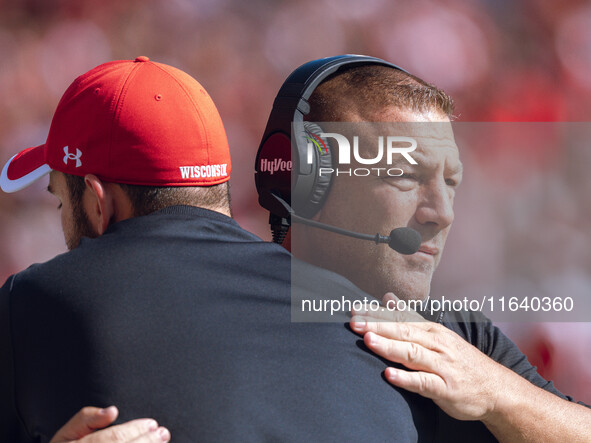 Wisconsin Badgers Offensive Coordinator Phil Longo embraces a member of the coaching staff minutes before the Wisconsin Badgers vs. Purdue B...