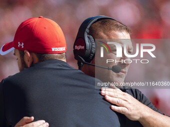 Wisconsin Badgers Offensive Coordinator Phil Longo embraces a member of the coaching staff minutes before the Wisconsin Badgers vs. Purdue B...