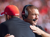 Wisconsin Badgers Offensive Coordinator Phil Longo embraces a member of the coaching staff minutes before the Wisconsin Badgers vs. Purdue B...