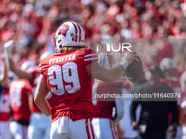 Wisconsin Badgers safety Cayson Pfeiffer #99 recovers a fumbled punt against the Purdue Boilermakers at Camp Randall Stadium in Madison, Wis...