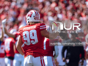 Wisconsin Badgers safety Cayson Pfeiffer #99 recovers a fumbled punt against the Purdue Boilermakers at Camp Randall Stadium in Madison, Wis...