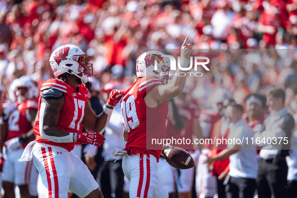 Wisconsin Badgers safety Cayson Pfeiffer #99 recovers a fumbled punt against the Purdue Boilermakers at Camp Randall Stadium in Madison, Wis...