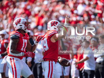 Wisconsin Badgers safety Cayson Pfeiffer #99 recovers a fumbled punt against the Purdue Boilermakers at Camp Randall Stadium in Madison, Wis...