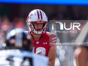 Wisconsin Badgers quarterback Braedyn Locke #18 observes the Purdue Boilermakers defense at Camp Randall Stadium in Madison, Wisconsin, on O...